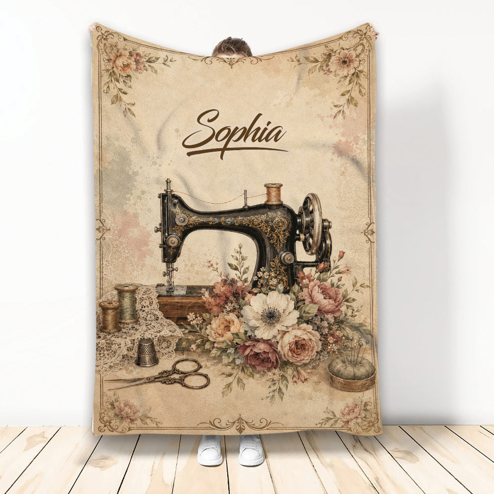Vintage sewing machine blanket with floral artwork, thread spools, scissors, thimble and pincushion
