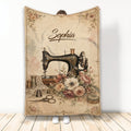 Vintage sewing machine blanket with floral artwork, thread spools, scissors, thimble and pincushion