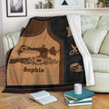 Sewing throw blanket styled on a sofa with floral sewing machine artwork and tailoring symbols