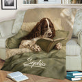 English Springer Spaniel reading on a book-themed blanket styled in a cozy living room