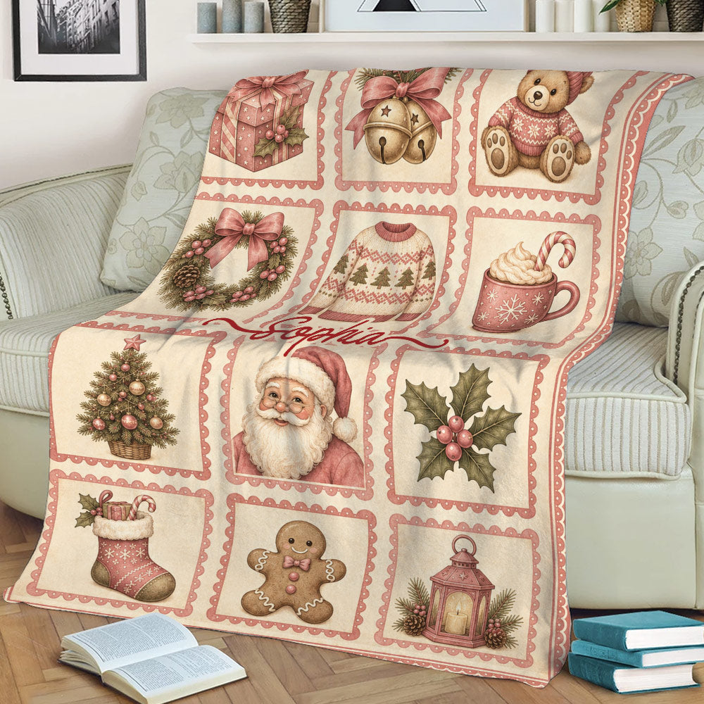Christmas throw blanket displayed on a couch with Santa, a tree, stockings, gingerbread, and festive panels