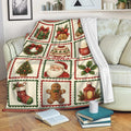 Custom Christmas throw blanket displayed on a sofa with Santa, holiday gifts and festive collage panels