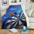 Dart board throw blanket draped over a sofa in a cozy living room setting