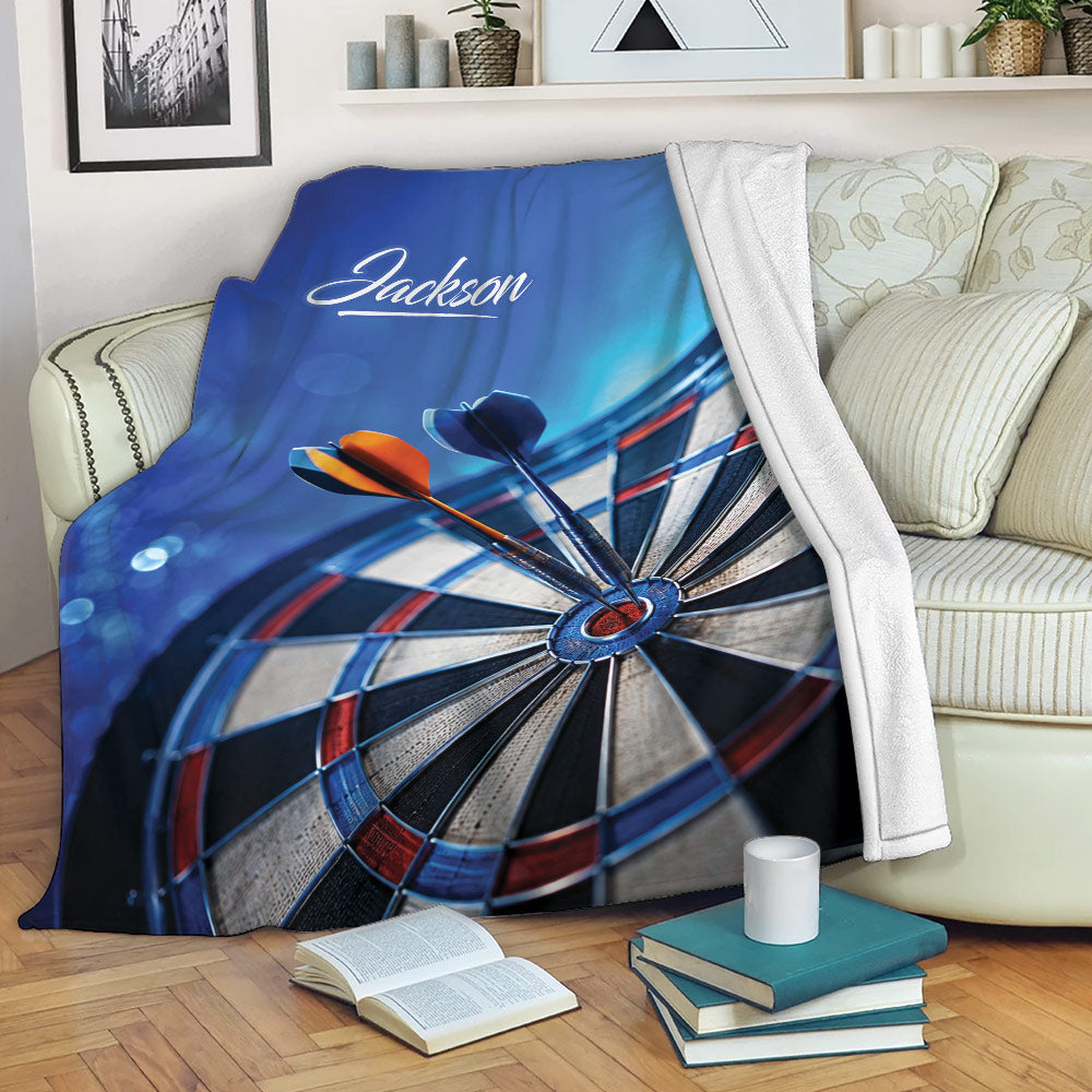 Dart board throw blanket draped over a sofa in a cozy living room setting