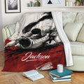 Jiu Jitsu throw blanket displayed on a sofa with dynamic grappling artwork in a black, white, and red design