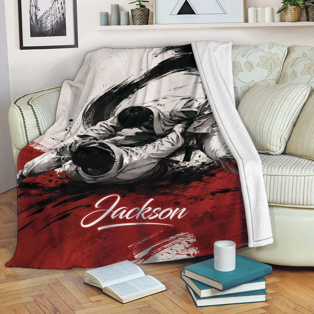 Jiu Jitsu throw blanket displayed on a sofa with dynamic grappling artwork in a black, white, and red design