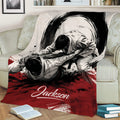 Jiu Jitsu blanket draped over a sofa, showing two martial artists grappling in a dramatic brushstroke design