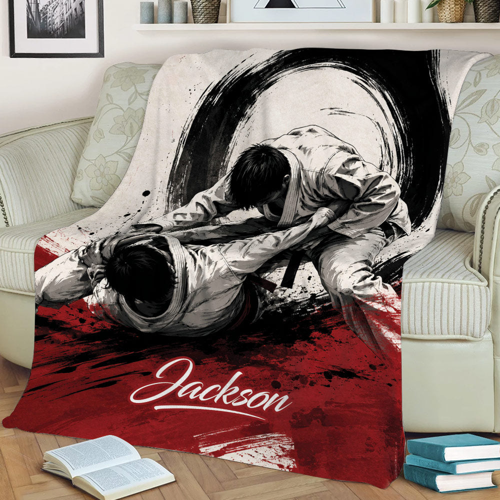 Jiu Jitsu blanket draped over a sofa, showing two martial artists grappling in a dramatic brushstroke design
