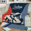 Close view of Jiu Jitsu grappling artwork on a throw blanket draped across a sofa