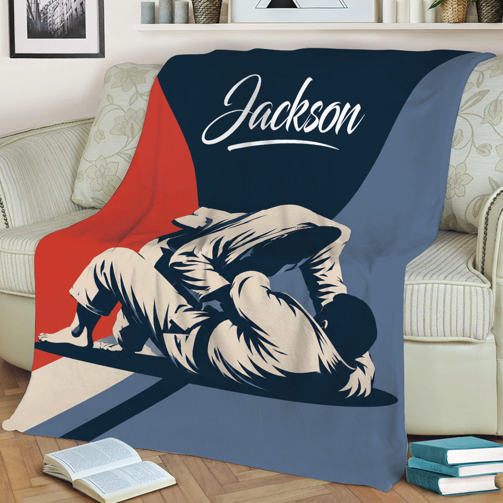 Close view of Jiu Jitsu grappling artwork on a throw blanket draped across a sofa