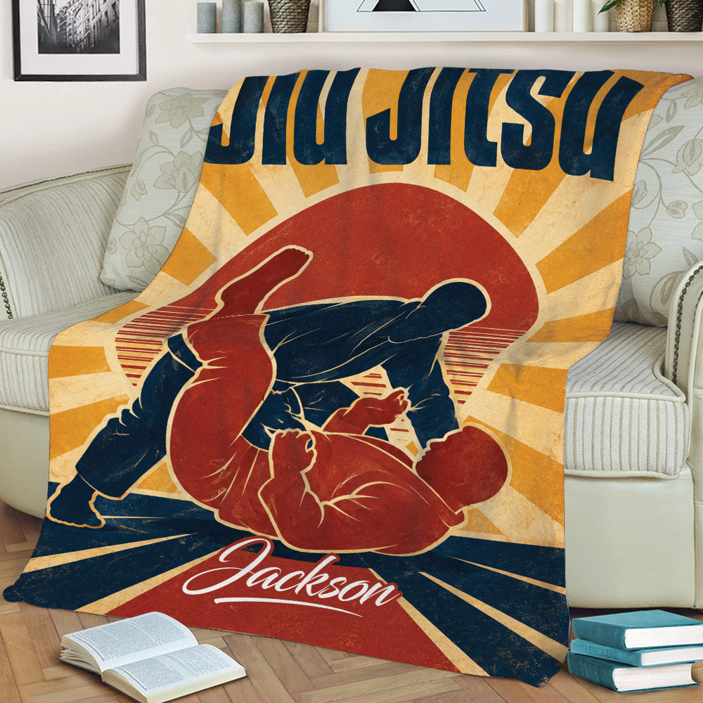 Jiu Jitsu throw blanket displayed on a couch with bold grappling silhouettes and sunburst artwork