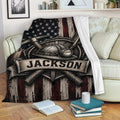Miner blanket displayed on a sofa with crossed mining tools, helmet, shovel, and rustic flag design