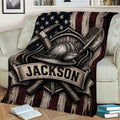 Close view of a miner throw blanket featuring a helmet, pickaxes, shovel, and rugged patriotic artwork