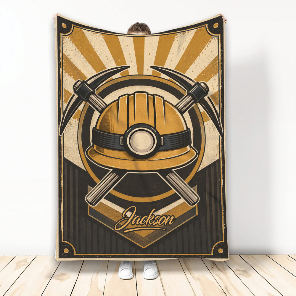 Miner blanket featuring a vintage gold hard hat and crossed mining picks in bold black and gold artwork