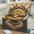 Mining-themed blanket draped over a couch with bold gold hard hat and crossed pickaxe artwork