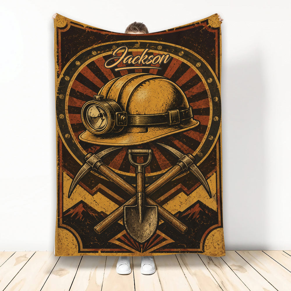 Vintage miner blanket design with hard hat, headlamp, pickaxes, shovel, and mountain artwork