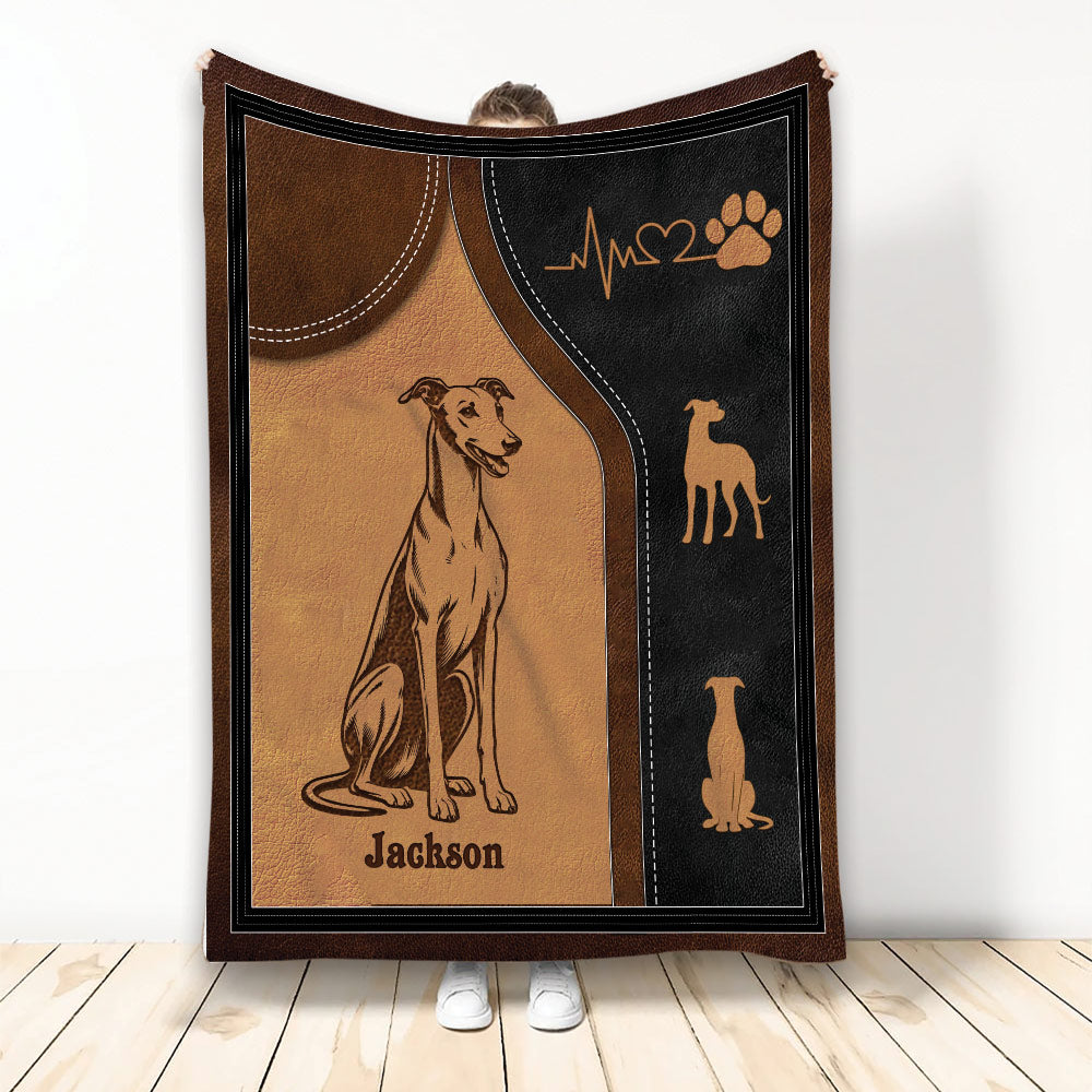 Greyhound blanket displayed with vintage leather-look artwork, paw print, heartbeat motif, and decorative dog silhouettes