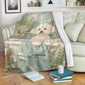 Bichon Frise throw blanket displayed on a sofa with a spa-themed dog design and floral accents