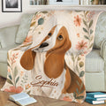 Floral Basset Hound throw blanket displayed on a sofa with warm botanical artwork