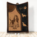 Brown and black Basset Hound throw blanket with paw print and heartbeat artwork