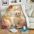 Maltese dog blanket displayed on a sofa with romantic flowers and soft vintage-inspired colors