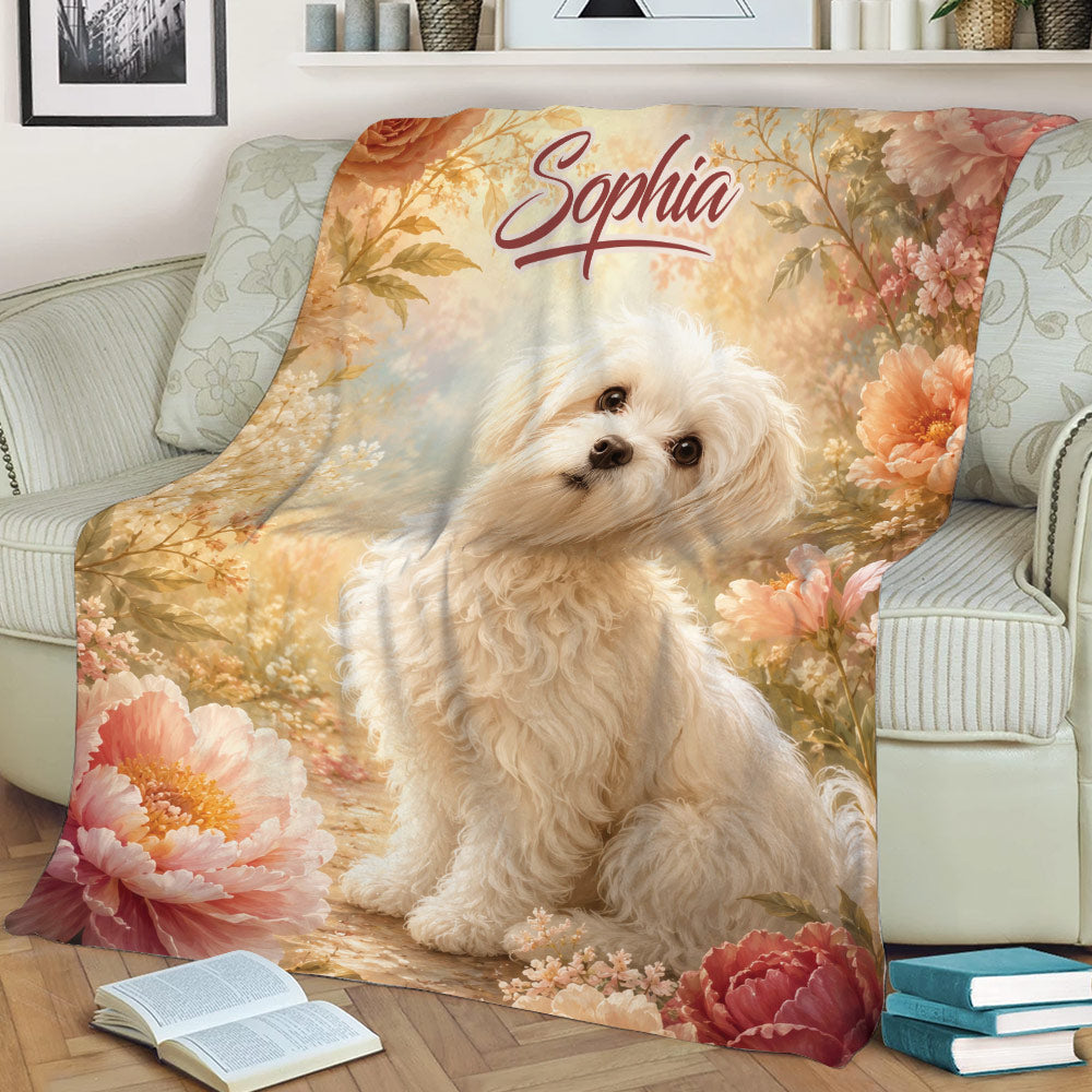 Floral Maltese throw blanket draped across a sofa, featuring a fluffy white dog and garden scenery