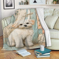 Maltese throw blanket draped over a sofa, featuring a fluffy white dog and rustic pastel artwork