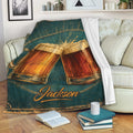 Beer throw blanket draped over a sofa with vintage clinking mugs and golden foam artwork