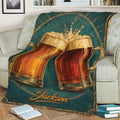 Close view of a cozy beer blanket on a couch with illustrated amber beer mugs