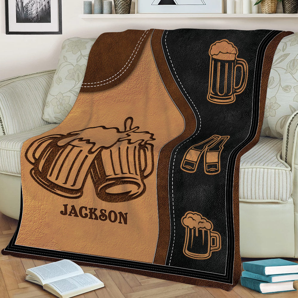 Close view of beer throw blanket featuring clinking mugs, bottle icons, and stitched border details