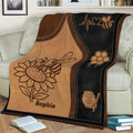 Honeybee throw blanket displayed on a couch with sunflower and honey-themed decorative artwork