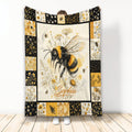 Bee throw blanket featuring a large honeybee, wildflowers, honeycomb panels, and black and golden floral borders