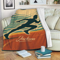 Custom running blanket draped over a sofa with a dynamic sprinter silhouette and warm retro colors