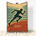 Running throw blanket featuring a sprinting athlete silhouette in retro teal, gold, and orange artwork