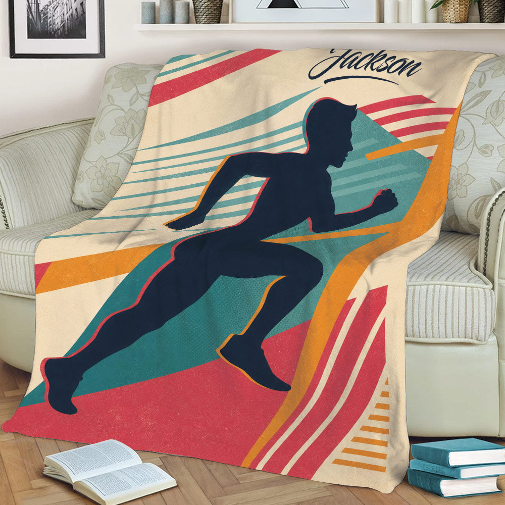 Runner design throw blanket displayed on a couch with colorful graphic accents