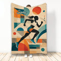 Running throw blanket featuring a female runner silhouette and bold retro geometric artwork