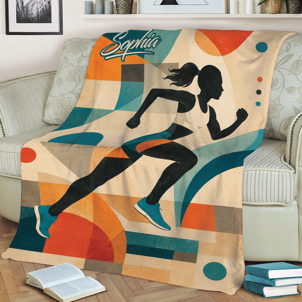 Close view of a running throw blanket with a female runner and teal, orange, and beige artwork