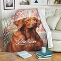 Vizsla dog throw blanket draped over a sofa with soft floral artwork and cozy living room decor