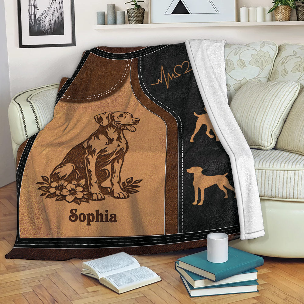 Vizsla throw blanket draped over a sofa with warm brown dog artwork and paw print accents