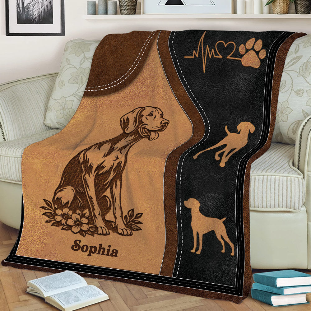 Close view of Vizsla dog artwork on a brown and black throw blanket with paw and heartbeat motifs