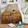 German Shorthaired Pointer throw blanket displayed on a sofa with rustic field and sunset artwork