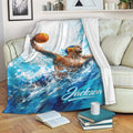 Water polo blanket displayed on a sofa with blue water artwork and an action-oriented player design