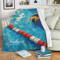 Water polo throw blanket draped over a sofa with blue pool artwork and floating ball design