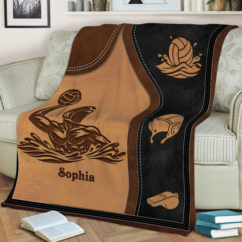 Close view of water polo throw blanket featuring a player, ball, cap, and whistle design