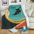 Skateboarding blanket draped over a sofa with bold teal, orange, green, and black geometric design