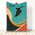 Skateboarding throw blanket with a silhouetted rider, skateboard, and retro teal geometric artwork