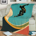 Close view of a skateboarding throw blanket featuring an airborne rider and distressed retro artwork