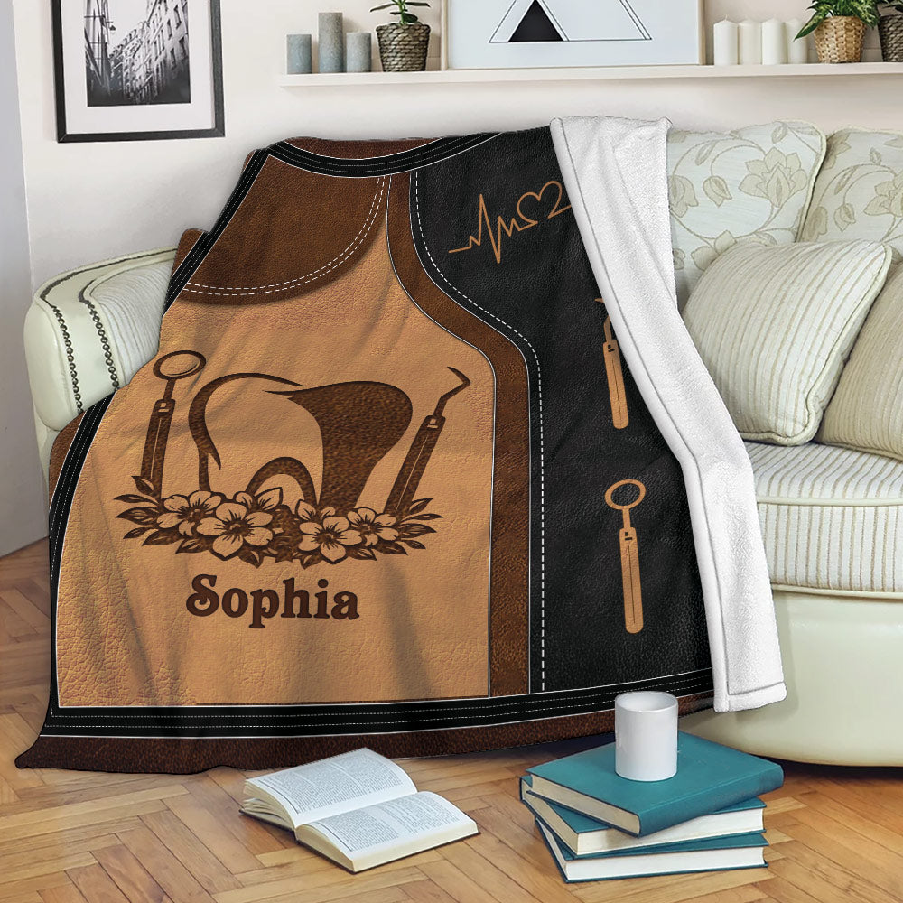 Dental Hygienist throw blanket displayed on a sofa with tooth and dental instrument artwork