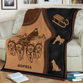 Rustic sledding blanket displayed on a sofa with dogs pulling a sled through a mountain landscape