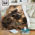 Custom ATV blanket displayed on a sofa with dynamic quad bike artwork and an off-road mountain scene